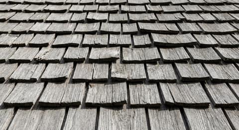 Close-up picture of cedar shake roofing showing the texture and profile of the material
