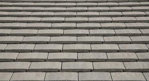 Close-up picture of concrete tile roofing showing the texture and profile of the material