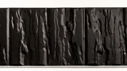 Close-up picture of embossed steel roofing showing the texture and profile of the material