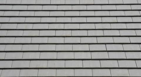 Close-up picture of flat tile roofing showing the texture and profile of the material