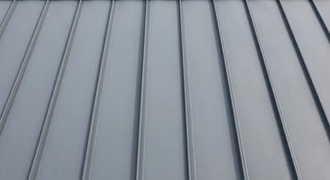 Close-up picture of standing seam metal roofing showing the texture and profile of the material