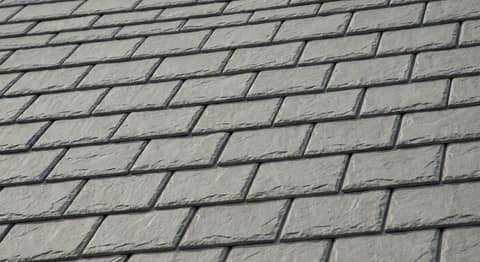 Close-up picture of synthetic slate roofing showing the texture and profile of the material