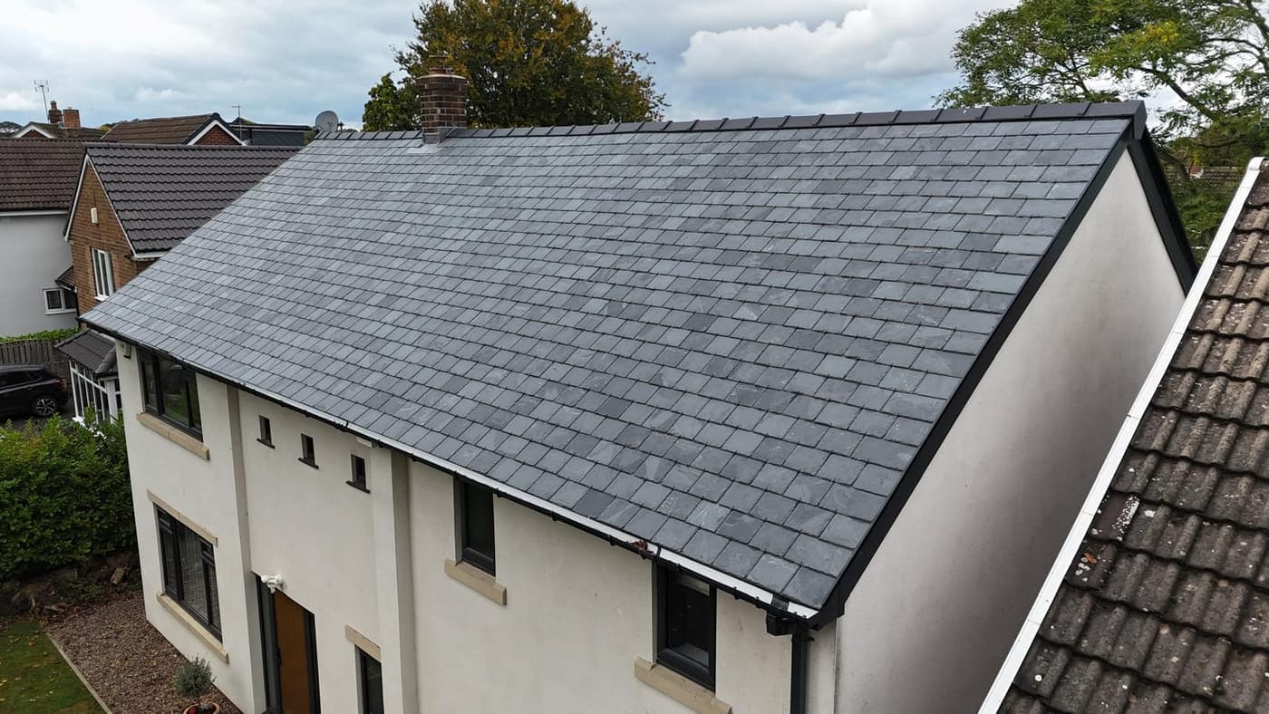 Before: Grey shingle to black standing seam