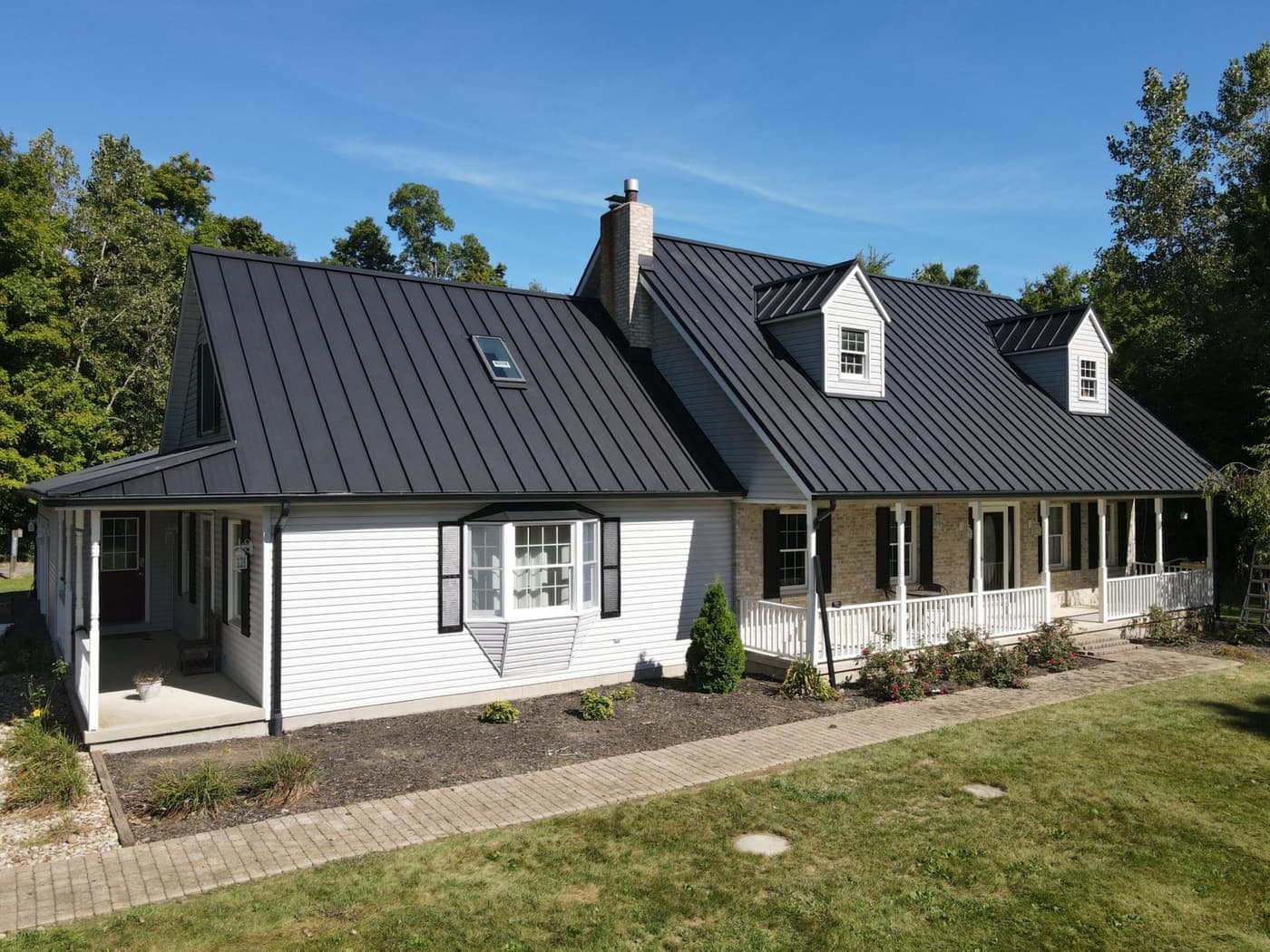 Before: Black standing seam to clay tile